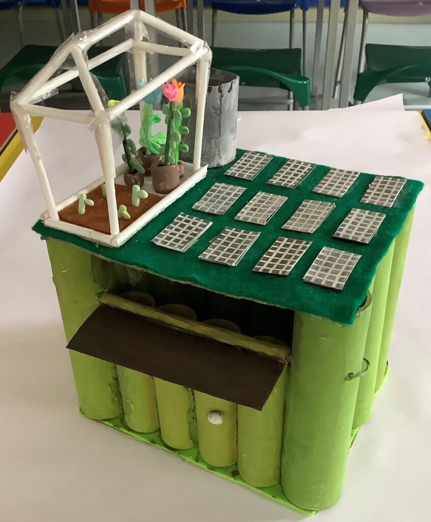 A different view of the building on green cylinders showing the rooftop vegetable plot in the greenhouse and the inside of the building.